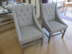 Two upholstered light grey contemporary armchairs