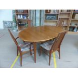 Mid-Century Dining table and four chairs (two carvers) with upholstered seats and two extension