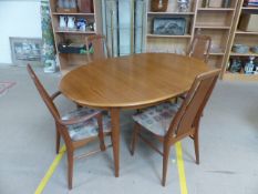 Mid-Century Dining table and four chairs (two carvers) with upholstered seats and two extension