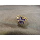 9ct gold ladies ring with mounted flower of five Tanzanite petals