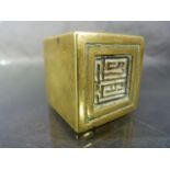 Brass oriental seal in the form of a cube, one side carved to form the stamp/seal.