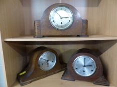 Three Art Deco oak veneered mantle clocks over two shelves
