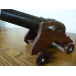 Bronze table cannon on later wooden stand with wheels