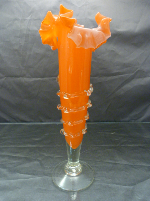A Ribbed orange glass bud vase with applied clear glass frills. 20th Century probably part of a