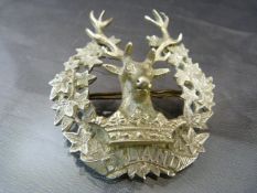 A Scottish GORDON HIGHLANDER electroplate Bydand armorial pin