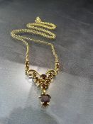9ct Gold (1989) Garnet necklace on a 20" POW chain marked 9ct. The pendant finished in a heart