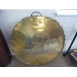 Large circular brass charger with Pie-Crust style shaped edge, etched with detailing of dragons