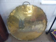 Large circular brass charger with Pie-Crust style shaped edge, etched with detailing of dragons