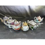 Seven miniature Teapots by Porcelain Arts. Some with tags