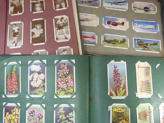 Three albums containing various Wills and Churchmans cigarette cards