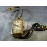 9ct Rose Gold cased watch on string bracelet. No Makers mark.