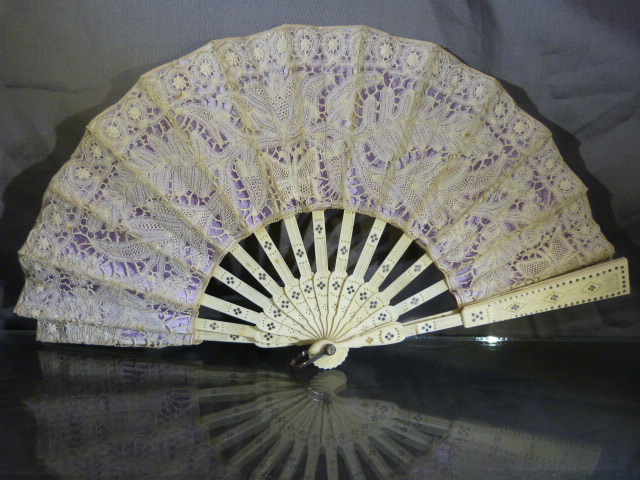 Victorian openwork ivory and lacework fan. Inlaid with a white coloured metal and pierced