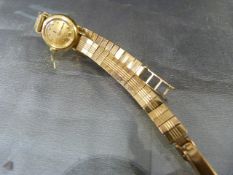 Ladies Vintage 9ct Omega dress watch with 9ct bracelet. Damage to glass. Two diamonds set into 12