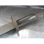 Borneo Head Hunters Sword with single metal blade and wooden metal handle. The blade with wavy