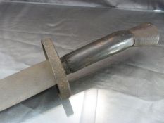 Borneo Head Hunters Sword with single metal blade and wooden metal handle. The blade with wavy