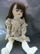 Mid Century Bisque headed doll by Seeley. Brunette hair and open eyes. Articulated movement to knees