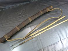 Hollowed stick in the form of a Quiver with bamboo Pygmy arrows inside. Hide binding and strap.