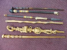 Six African/ tribal items to include a spear, carved walking sticks and a nyami nyami stick