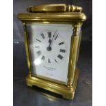 Brass Carriage clock by Mappin and Webb. 5 Glass panelled clock (oval panel to top) is marked to the