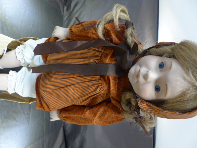 A 1979 Alresford Toys china girl doll in original packaging. Blonde wig with orange coloured