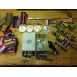 A collection of militaria to include five unmarked medals, ribbons, bars stars, RAF pin etc