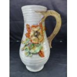 A Clarice Cliff Jug decorated with embossed Autumn fruits and flowers. No 914. Embossed mark to