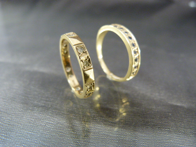 Two 9ct Eternity type rings. One set with half band of sapphires and the other set with Diamonds.