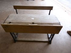 Wrought iron framed early double school desk. Lift top and seats.