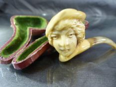 Carved Meerschaum pipe in the form of a head with hand on and curved mouthpiece.