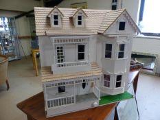 Large three story dolls house with opening roof and two fronts.