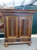 Carved Oak and Mahogany linen type press of two cupboards and two drawers under. The doors having