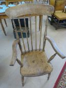 Lovely example of an Elm Windsor armchair with stick backs. The wood showing knots and grains