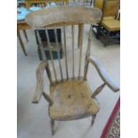 Lovely example of an Elm Windsor armchair with stick backs. The wood showing knots and grains