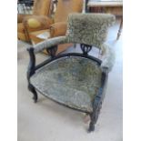 Smokers armchair with open arms and on castors. Upholstery in need of attention. Scrolled back
