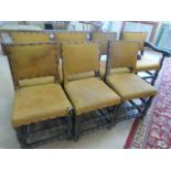 Set of seven oak dining room chairs with fabric upholstery. Legs with turned double stretchers