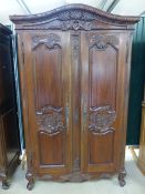 Stained pine and carved wooden wardrobes. Curved frieze to top carved with Pheasants and flora