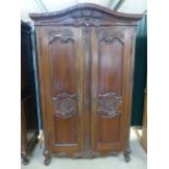 Stained pine and carved wooden wardrobes. Curved frieze to top carved with Pheasants and flora