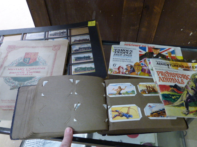 Selection of framed cigarette cards and cigarette cards in albums. Mainly Brooke Bond.