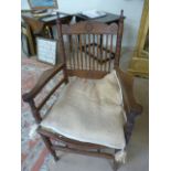 American oak carver chair in the Arts and Crafts Style. The Back with turned wooden spindle back