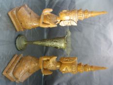 Pair of middle eastern kneeling carved figures and a middle eastern silver coloured metal bud vase