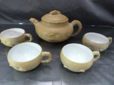 Chinese Yixing stoneware teapot and lid of yellowish tan colour with FOUR tea cups having glazed