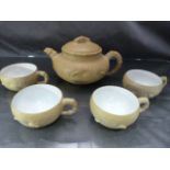 Chinese Yixing stoneware teapot and lid of yellowish tan colour with FOUR tea cups having glazed