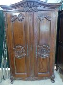 Stained pine and carved wooden wardrobes. Curved frieze to top carved with Pheasants and flora. (