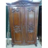 Stained pine and carved wooden wardrobes. Curved frieze to top carved with Pheasants and flora. (