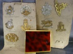 Selection of 10 cap badges and a cigarette case