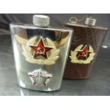 Two Russian Hip Flasks marked with the Hammer and Sycle. Marked to bases Pocona and one other