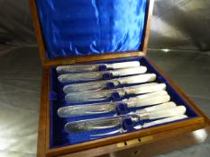 A set of twelve Victorian mother-of-pearl handled fruit knives and forks presented in inlayed box