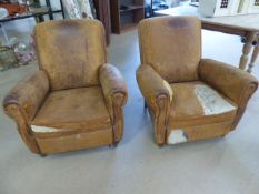 Pair of French Tan leather club chairs. Both in need of re-upholstery.