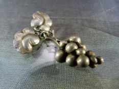 A George Jensen silver pendant brooch formed as a bunch of grapes & suspended from two leaves, the