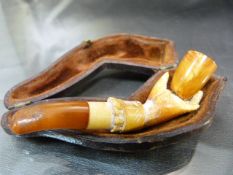 Carved Meerschaum in the form of a hand holding a bowl. Bowl made from amber as is the Mouthpiece in